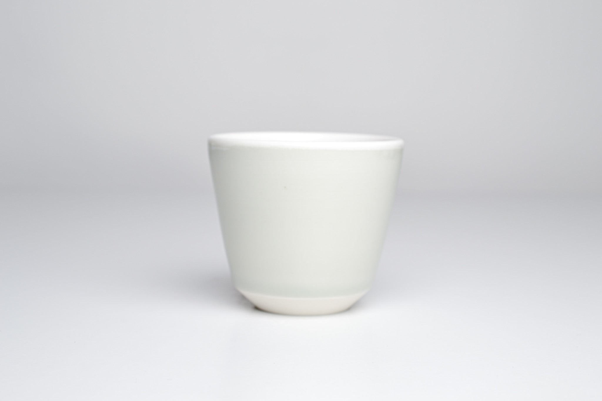 Celadon cup with black line